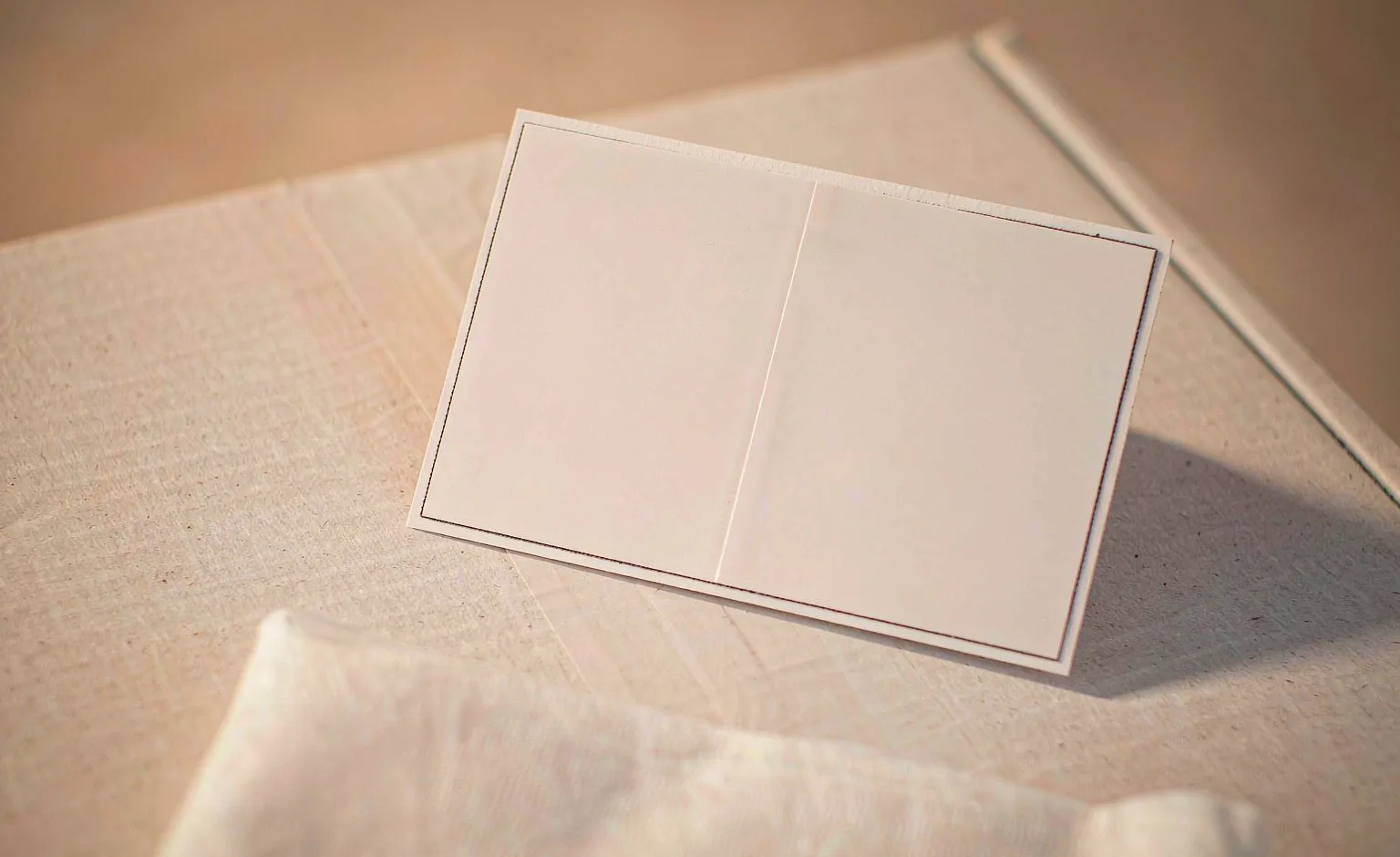 A shipping label and a folded white nonwoven sheet on a plain surface, with no branding visible.